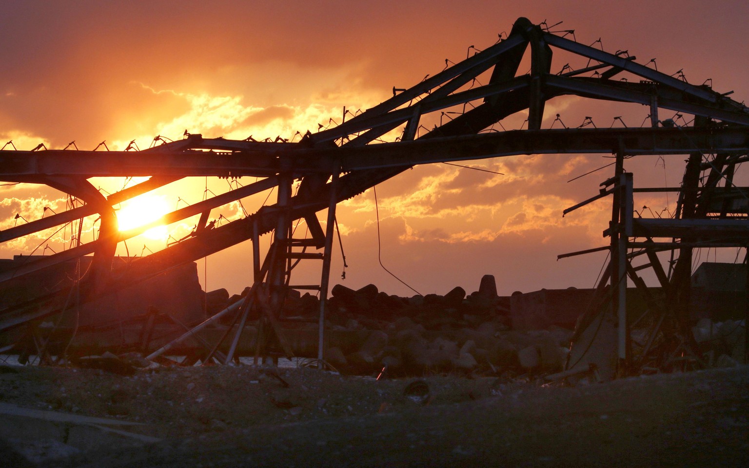 The sun rises over tsunami damaged structures in Tomioka, Fukushima prefecture, northern Japan Wednesday, March 11, 2015. Japan marked the fourth anniversary on Wednesday of the devastating disasters  ...