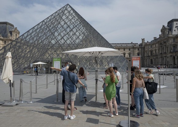 Visitors enter after registering for COVID-19 tests at the Louvre museum in Paris, Friday, July 23, 2021. Visitors now need a special COVID pass to visit French museums or movie theaters, the first st ...