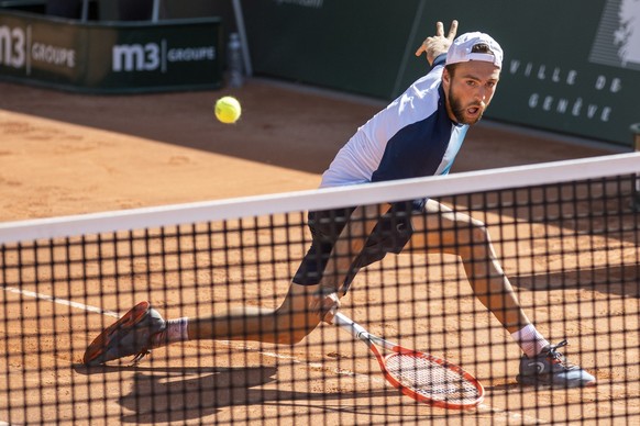 Johan Nikles, of Switzerland, returns a ball to Tallon Griekspoor of Netherlands, during their second round match, at the ATP 250 Geneva Open tournament in Geneva, Switzerland, Wednesday, May 18, 2022 ...