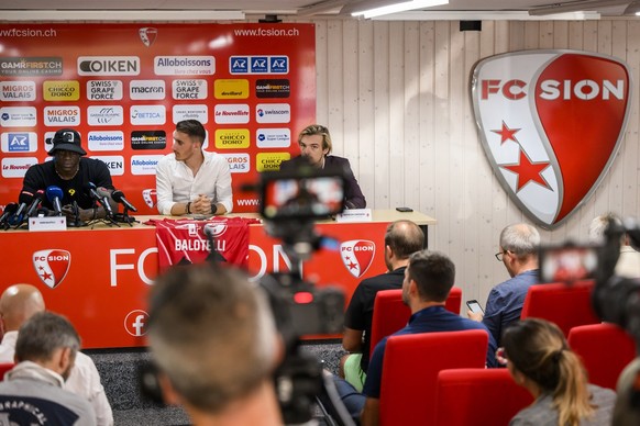 Mario Balotelli of Italy and new FC Sion soccer player, left, speaks next to Baptiste Coppey, center, communication manager and Barthelemy Constantin, right, sport director of FC Sion, during a press  ...