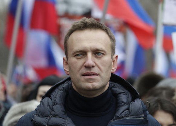 FILE - In this Sunday, Feb. 24, 2019 file photo, Russian opposition activist Alexei Navalny takes part in a march in memory of opposition leader Boris Nemtsov in Moscow, Russia. In August 2020, the op ...