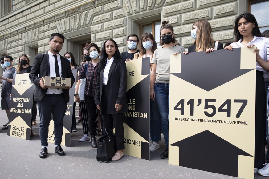 Navid Majidi, gebuertiger Afghane, vorne links, und Maryam Sediqi, gebuertige Afghanin, vorne rechts, bei der Uebergabe der Unterschriften des Appels fuer die Aufnahme von Fluechtlingen aus Afghanista ...