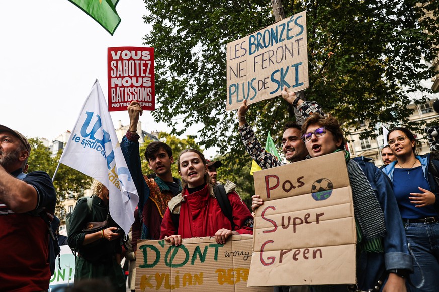 epa10201675 Demonstrators take part in the Global Climate Strike rally of Fridays for Future next to Academy Du Climat in Paris, France, 23 September 2022. Fridays for Future demonstrate for a system  ...