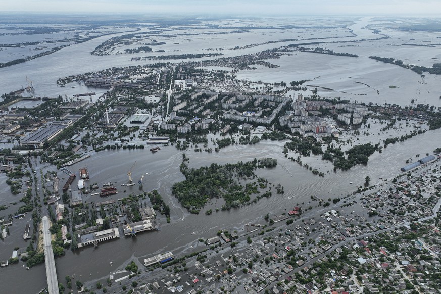 Houses are seen underwater and polluted by oil in a flooded neighbourhood in Kherson, Ukraine, Saturday, June 10, 2023. The destruction of the Kakhovka Dam in southern Ukraine is swiftly evolving into ...