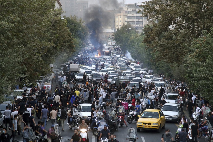 FILE - In this photo taken by an individual not employed by the Associated Press and obtained by the AP outside Iran, protesters chant slogans during a protest over the death of a woman who was detain ...