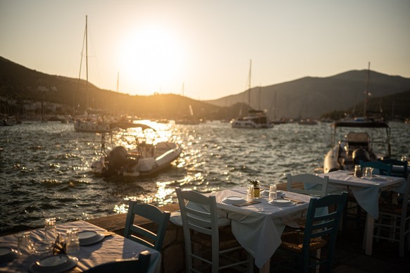 Tables are set at a waterfront restaurant in the town of Vathy on the island of Ithaca, in the Ionian Sea, on August 3, 2026. Ithaca, the home to the hero Odysseus in Homer's Odyssey, is far from ...