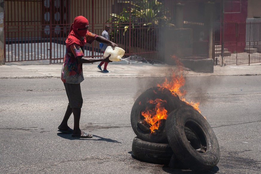 epa10058071 A man participates in a protest calling for justice for the assassination of President Jovenel Moise, during the anniversary of his assassination, in Port-au-Prince, Haiti, 07 July 2022. S ...