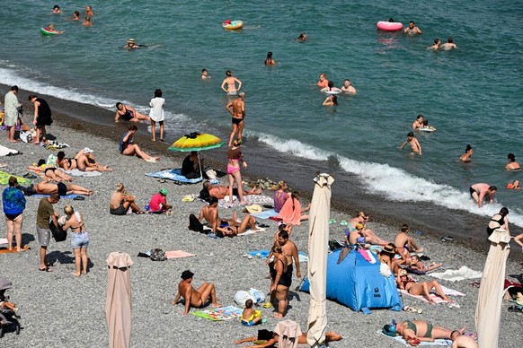 People sunbathe on a beach in Yalta, on the Russian-annexed peninsula of Crimea, on July 22, 2026. Ukraine has heavily targeted the Black Sea territory -- a popular summer retreat despite the four-and ...