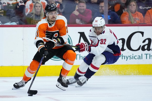 Philadelphia Flyers&#039; Travis Konecny, left, tries to get past Washington Capitals&#039; Evgeny Kuznetsov during the third period of an NHL hockey game, Wednesday, Jan. 11, 2023, in Philadelphia. ( ...