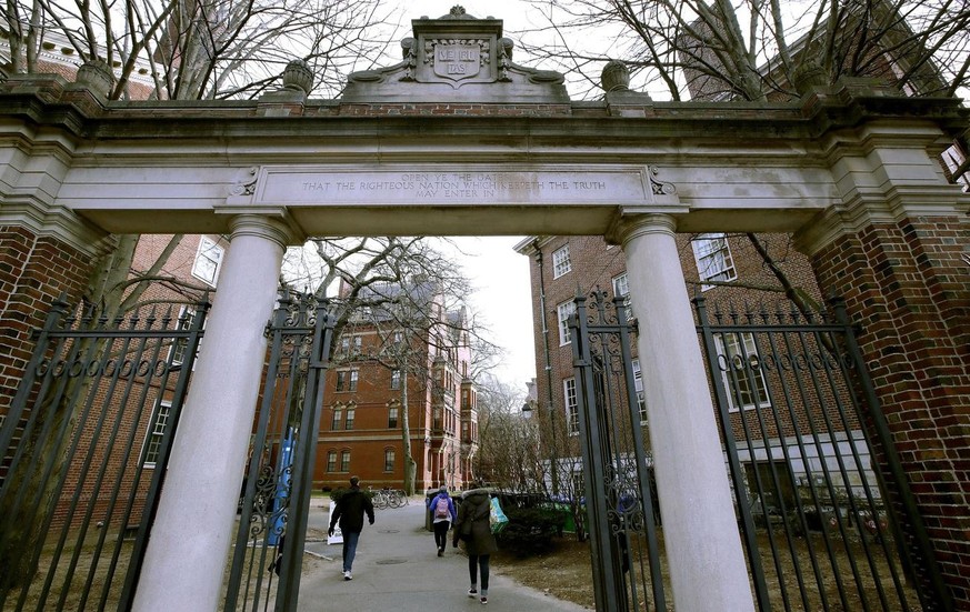 FILE - A gate opens to the Harvard University campus, on Dec. 13, 2018, in Cambridge, Mass. Three Harvard University graduate students said in a federal lawsuit filed Tuesday, Feb. 8, 2022, that the I ...