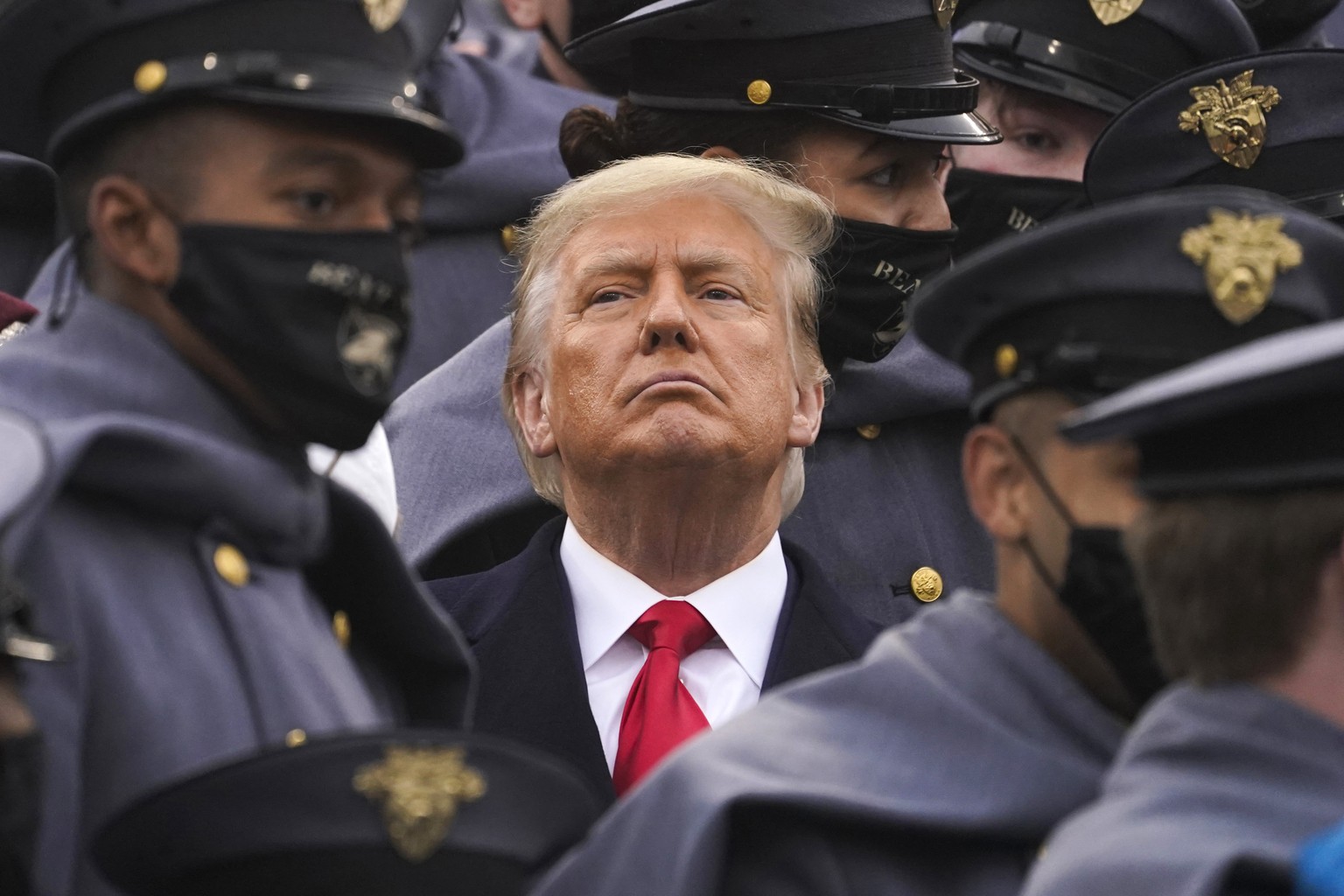 FIlE - Surrounded by Army cadets, President Donald Trump watches the first half of the 121st Army-Navy Football Game in Michie Stadium at the United States Military Academy, Saturday, Dec. 12, 2020, i ...