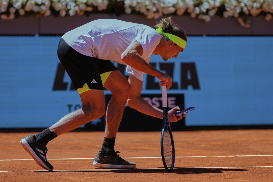 Alexander Zverev of Germany takes a picture with his phone during his Madrid Open round of 32 tennis match against Alejandro Davidovich Fokina of Spain, in Madrid, Spain, Sunday, April 27, 2025. (AP P ...