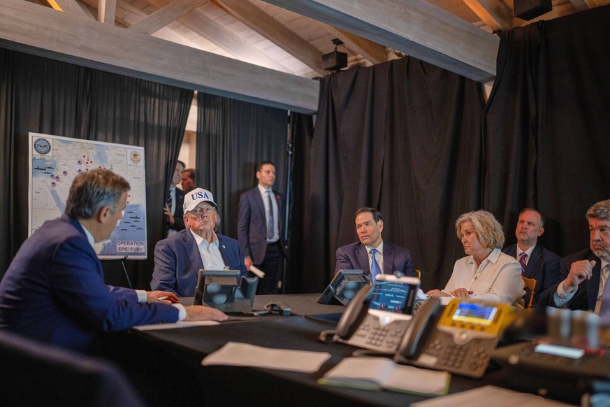 This photo provided by the White House which has been partially blurred, shows President Donald Trump talking with CIA Director John Ratcliffe, left, Secretary of State Marco Rubio, and White House ch ...