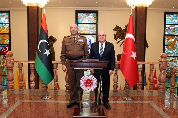 In this photo released by the Turkish Defense Ministry, Turkey's Chief of General Staff Gen. Selcuk Bayraktaroglu, right, poses for a photograph with Libyan Chief of General Staff Gen. Mohamed Al ...