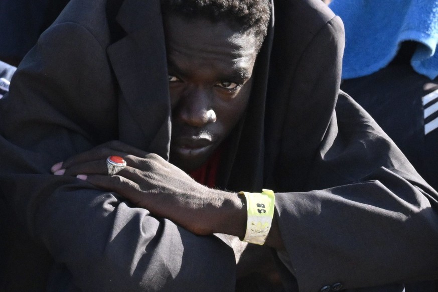 epa10861478 A migrant waits in line outside the hotspot to be transferred to other places from the Lampedusa island, southern Italy, 15 September 2023. A record number of migrants and refugees have ar ...