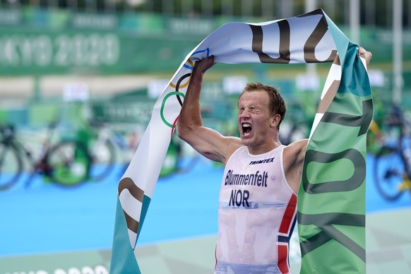 Kristian Blummenfelt of Norway celebrates after crossing the finish line to win the gold medal during the men&#039;s individual triathlon at the 2020 Summer Olympics, Monday, July 26, 2021, in Tokyo,  ...