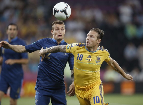 France&#039;s Mathieu Debuchy, left, and Ukraine&#039;s Andriy Voronin go for the ball during the Euro 2012 soccer championship Group D match between Ukraine and France in Donetsk, Ukraine, Friday, Ju ...