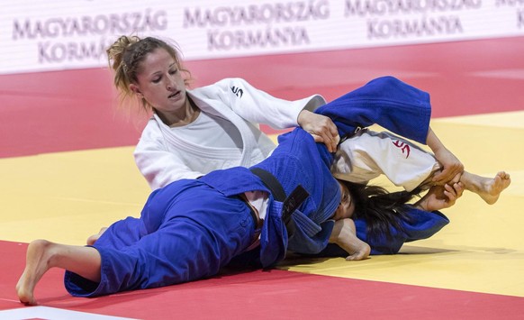 epa09253012 Fabienne Kocher (in white) of Switzerland and Gefen Primo (blue) of Israel fight in the women&#039;s -52kg category of World Judo Championships in Budapest, Hungary, 07 June 2021. EPA/Zsol ...