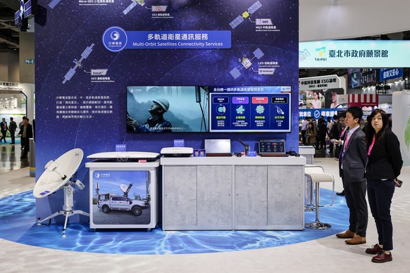 epa12826598 Staff stand next to their Multi-Orbit Satellite Connectivity Services display during the Smart City Summit &amp; Expo in Taipei, Taiwan, 17 March 2026. The Smart City Summit &amp; Expo (SC ...