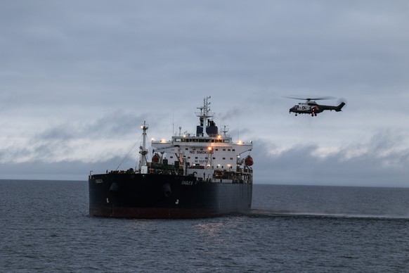 epa11795847 A handout photo made available by Finnish Border Guard shows a helicopter used by the authorities during an operation to transfer the Eagle S tanker from the Gulf of Finland to Svartbeck i ...