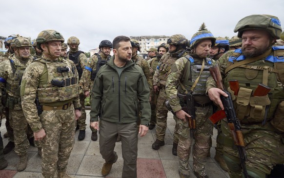 epa10183562 A handout photo made available by the presidential press service shows Ukrainian President Volodymyr Zelensky (C) attends a ceremony of the National flag rising in the reclaimed city of Iz ...