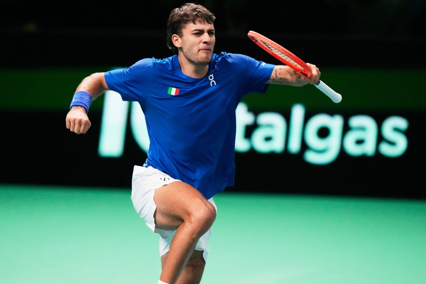 Italy&#039;s Flavio Cobolli celebrates after winning a set point against Spain&#039;s Jaume Munar during a Davis Cup final singles tennis match between Italy and Spain, in Bologna, Italy, Sunday, Nov. ...