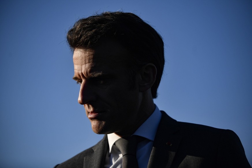 epa10558576 French President Emmanuel Macron looks on as he attends a football training session for neurodivergent children and youths with symptoms of autism spectrum disorder, at the Stade de la Pla ...