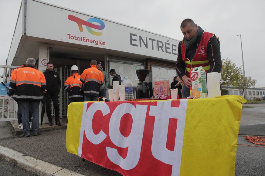 Striking workers gather at the entrance of the TotalEnergies oil depot, Thursday, Oct.13, 2022 outside Dunkirk, northern France. French President Emmanuel Macron promised the situation in the country& ...