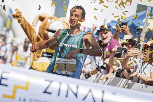 Kilian Jornet from Spain celebrates as he crosses the finish line to win the men&#039;s category and establish a new race record during the 51st Sierre-Zinal long distance mountain race in Zinal, Satu ...
