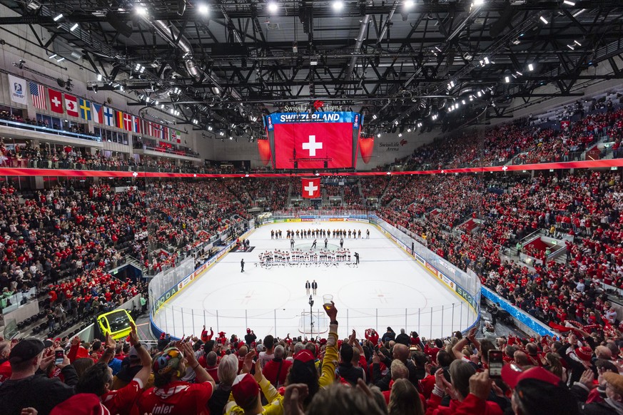 The Swiss and German teams stand as the fans cheer the Swiss team, after their 6:0 victory in the 2026 IIHF Men's Ice Hockey World Championship preliminary round group A game between Germany and  ...