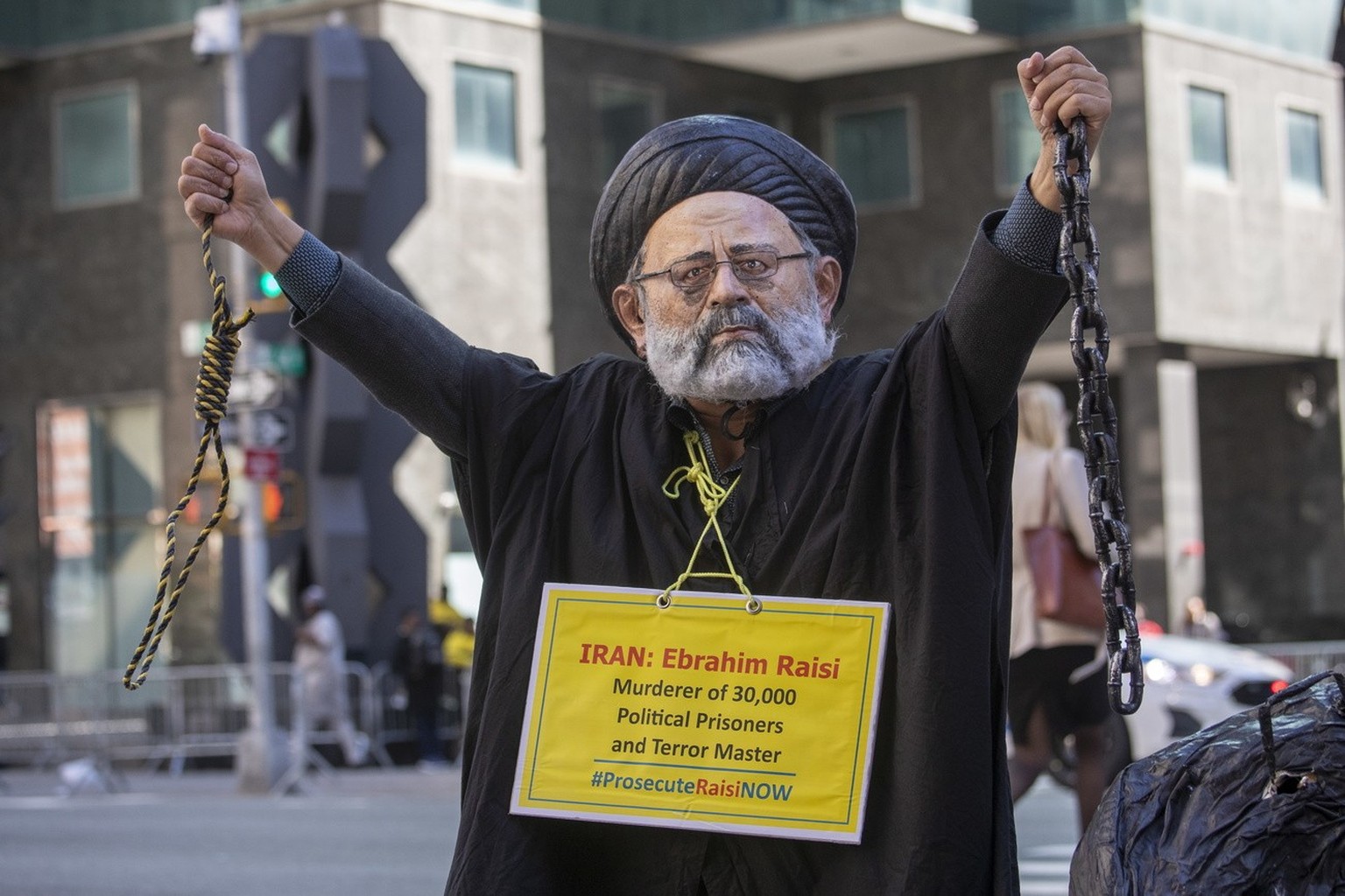 epa10201935 A person dressed as Iran President Ebrahim Raisi protests with the Organization of Iranian American Communities outside of a hotel Raisi frequents during his visits in New York, New York,  ...