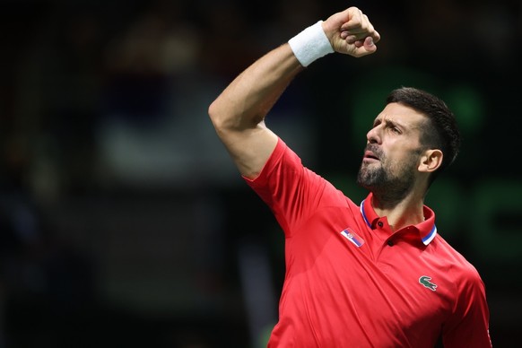 epa11605739 Novak Djokovic and Hamad Medjedovic (not pictured) of Serbia react as they play against Petros Tsitsipas and Aristotelis Thanos of Greece during the Davis cup, World Group I tennis match b ...