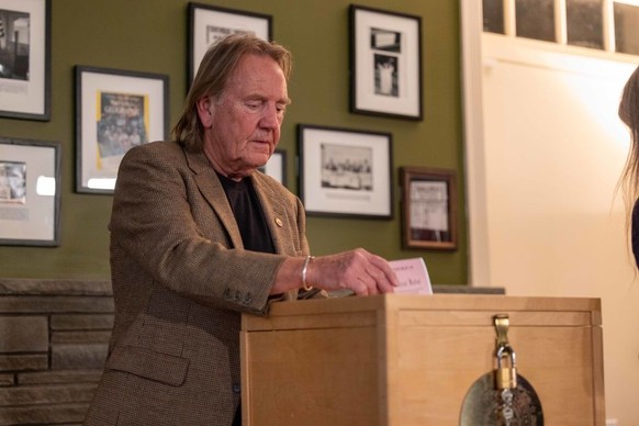 DIXVILLE NOTCH, NEW HAMPSHIRE - JANUARY 23: Dixville Town Moderator Tom Tillotson puts a ballot into the ballot box just after midnight on January 23, 2024 in Dixville Notch, New Hampshire. Dixville N ...