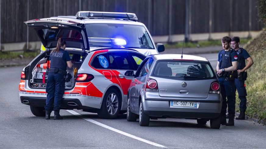 Police officers block a street near the Schachen horse racing track in Aarau following a shooting during a rave event at the Schachen horse racing track near Aarau, Switzerland on Sunday, August 30, 2 ...