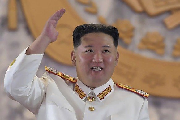 FILE - In this photo provided by the North Korean government, North Korean leader Kim Jong Un, center, watches a military parade to mark the 90th anniversary of North Korea's army at the Kim Il S ...
