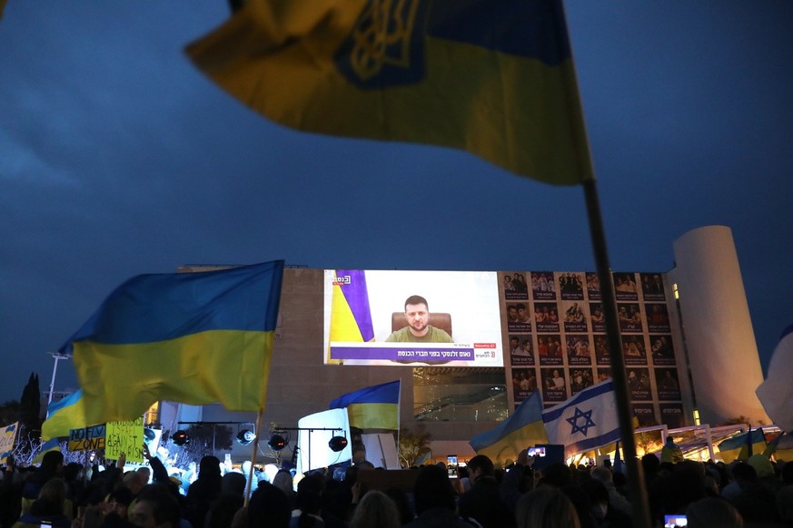 epa09838677 People watch Ukrainian President Volodymyr Zelensky speech broadcasted live at Habima square in Tel Aviv, Israel, 20 March 2022. Zelensky addressed the Israeli parliament Knesset members.  ...