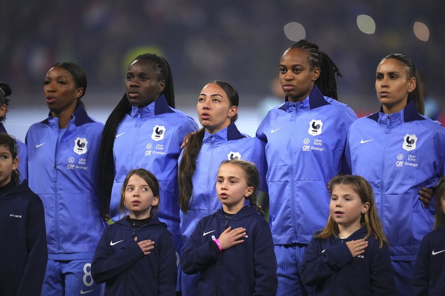 France national team players sing the anthem ahead the Nations League women&#039;s semifinal soccer match between France and Germany in Lyon, France, Friday, Feb. 23, 2024. (AP Photo/Daniel Cole)
