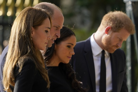 Britain&#039;s Prince William and Kate, Princess of Wales, left, and Britain&#039;s Prince Harry and Meghan, Duchess of Sussex view the floral tributes for the late Queen Elizabeth II outside Windsor  ...