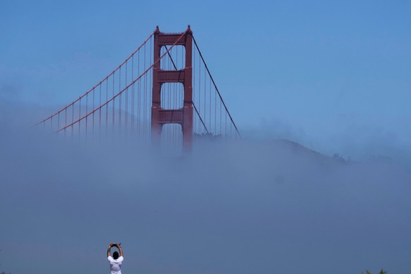 A person looks toward a tower of the Golden Gate Bridge partially covered by fog near Fort Point in San Francisco, Friday, May 30, 2025. (AP Photo/Jeff Chiu)
California Heat Wave