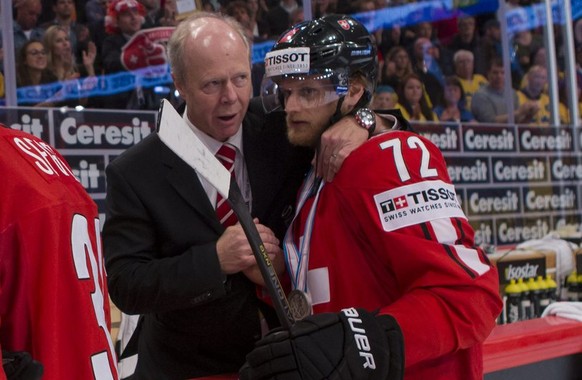 Switzerland&amp;#039;s players Mathias Seger, left, and Patrick von Gunten, right, are consoled after losing by Swiss leaders, in the Gold Medal game between Switzerland and Sweden at the IIHF 2013 Ic ...