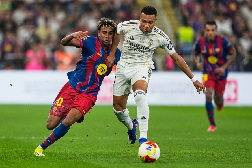 Barcelona's Lamine Yamal, left, duels for the ball with Real Madrid's Kylian Mbappe during the Spanish Super Cup final soccer match at King Abdullah Sports City Stadium in Jeddah, Saudi Arab ...