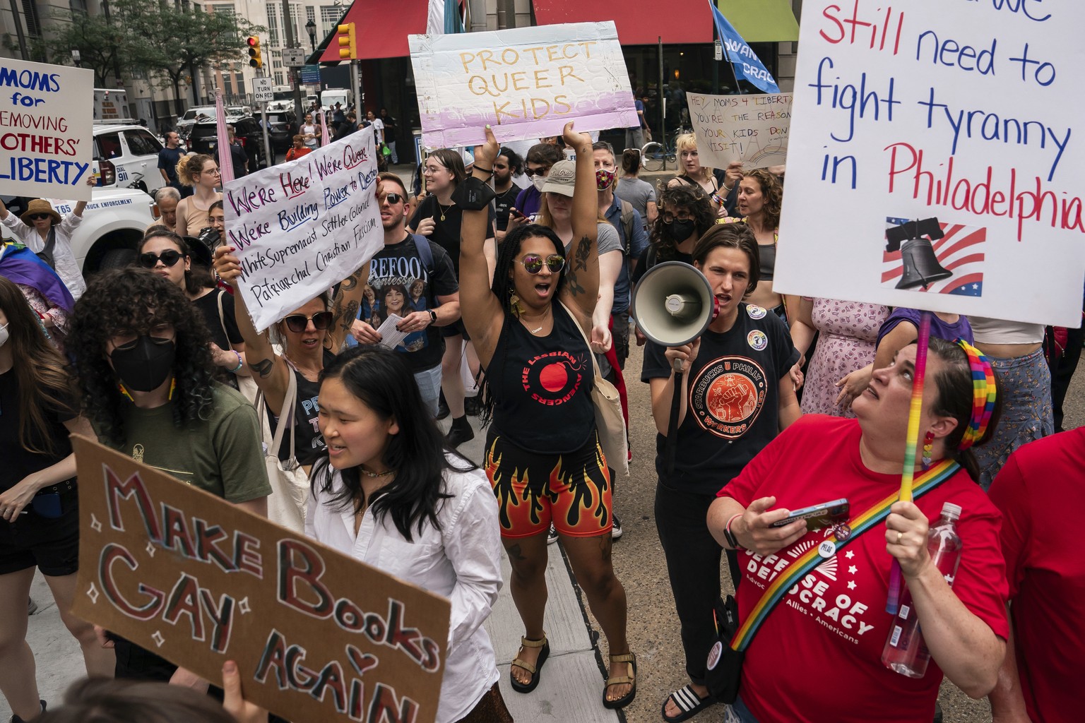 Demonstrators gather outside the Moms for Liberty meeting in Philadelphia, Friday, June 30, 2023. (AP Photo/Nathan Howard)