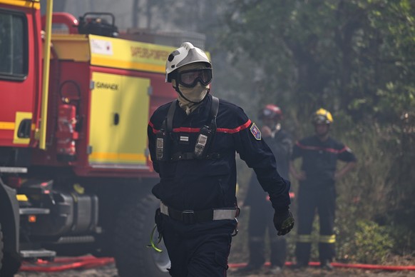 A firefighter works during a wildfire at the region the historic Fontainebleau forest, about 60 km (37 miles) south of Paris, France, Monday, July 13, 2026. (AP Photo/Emma Da Silva)
France Wildfires