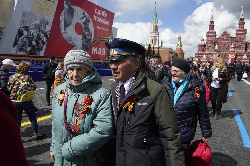 People walk after the Victory Day military parade in Moscow, Russia, Monday, May 9, 2022, marking the 77th anniversary of the end of World War II. (AP Photo/Alexander Zemlianichenko)