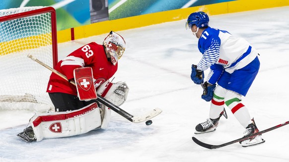 epa12749442 Switzerland's goaltender Leonardo Genoni saves a shot from Italy's Marco Zanetti during the Men's Qualification play-offs match between Switzerland and Italy of the Ice Hock ...