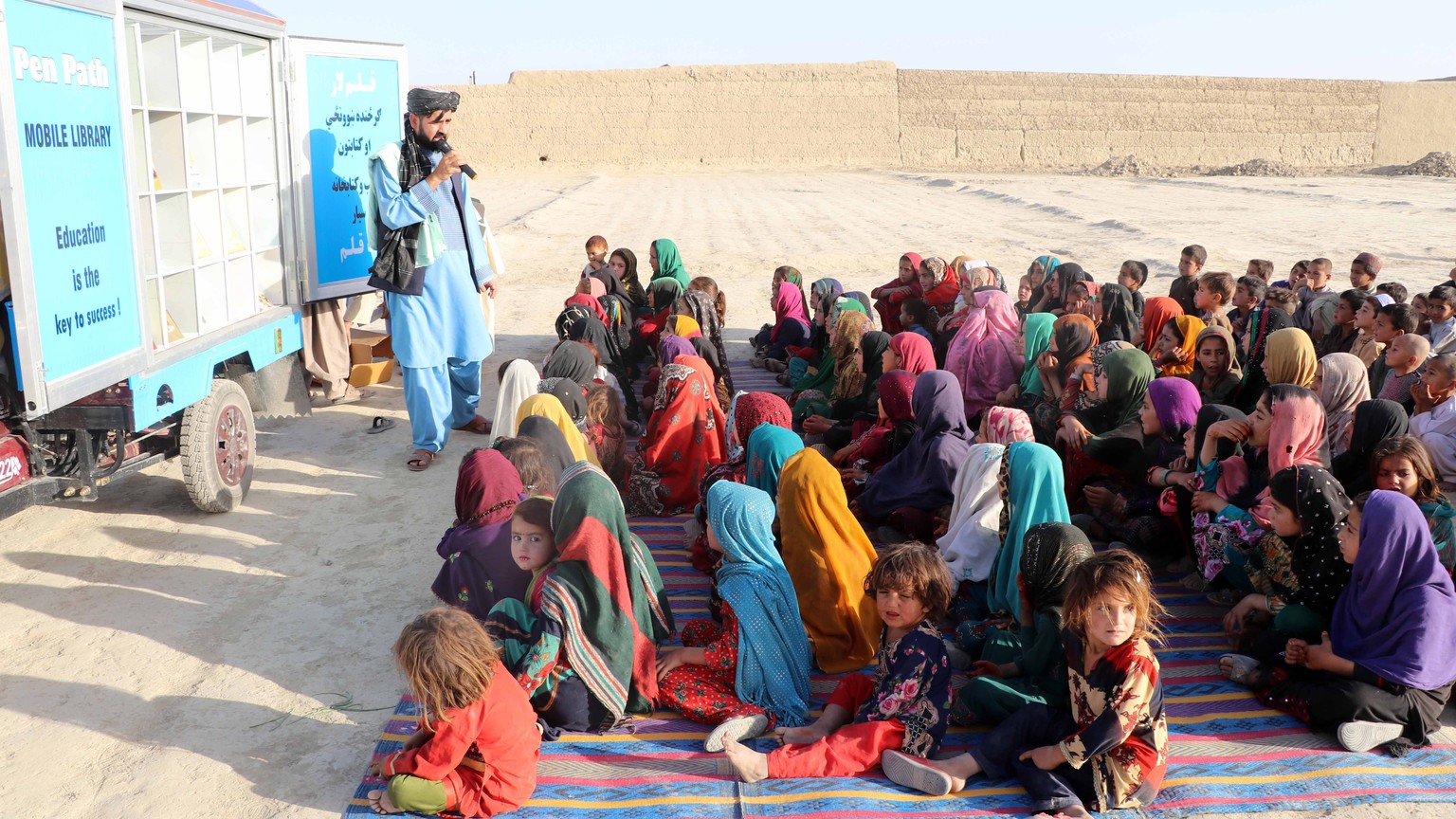 epa09956282 Afghan children attend an educational event organized by Pen Path, a civil society intiative providing education to Afghan children in areas where there is no school, in Kandahar, Afgahnis ...