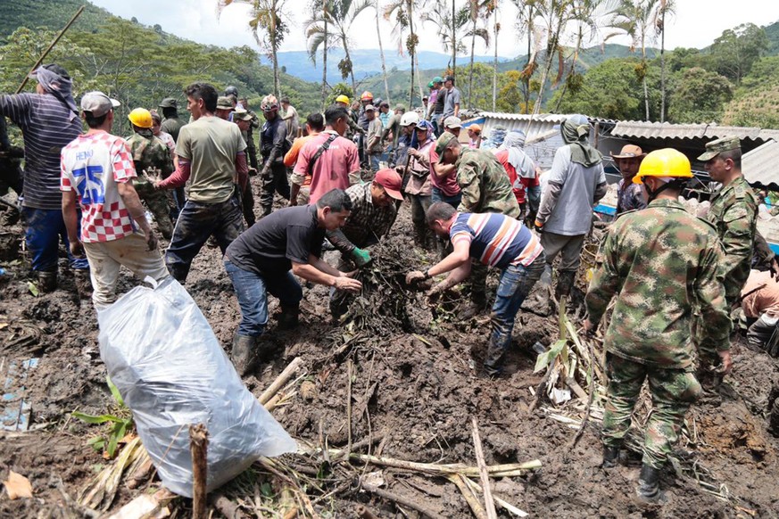 epa10071685 A handout photo made available by the Government of Antioquia shows members of the Army and relief groups while they work to rescue victims of a landslide that buried a school in Taparto, ...