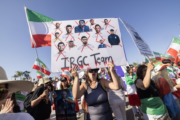epa13040267 Members of the Iranian diaspora hold signs during a protest outside Los Angeles Stadium ahead of the FIFA World Cup 2026 Group G soccer match between Iran and New Zealand in Inglewood, Cal ...