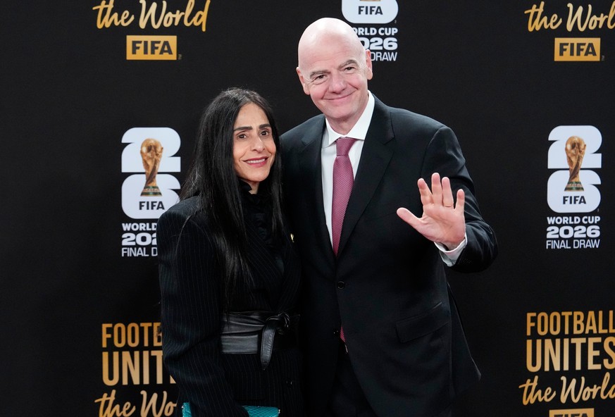 FIFA President Gianni Infantino and his wife Leena Al Ashqar pose for a photo as they arrive for a welcome reception ahead of the draw for 2026 soccer World Cup at the Kennedy Center in Washington, Th ...