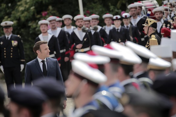 French President Emmanuel Macron reviews military troops during the ceremony of his inauguration for a second term at the Elysee palace, in Paris, France, Saturday, May 7, 2022. Macron was reelected f ...